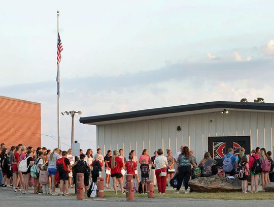 Gathered around the campus flagpole