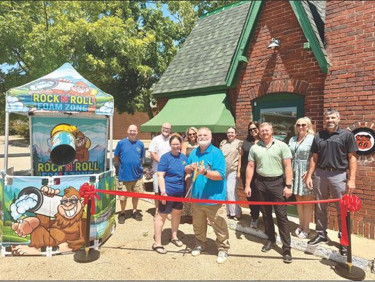 Members of the Atoka Area Chamber of Commerce gather alongside owner Steve Turrentine