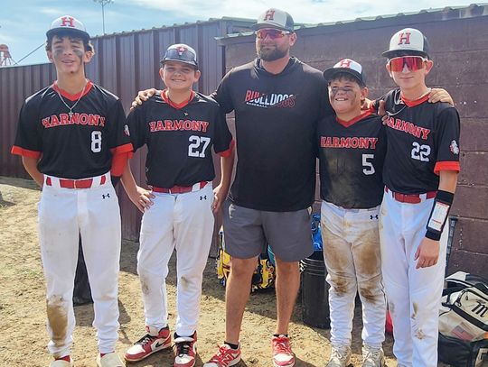 The eighth-grade members of the Harmony team pose with their coach after competing in their final Coleman Festival on September 19th