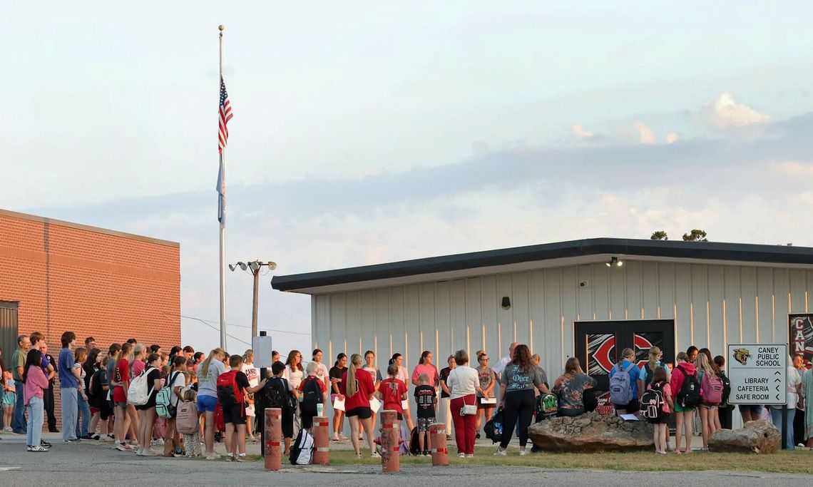 Gathered around the campus flagpole